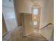 Carpeted staircase leads to an inviting front entrance, featuring a hanging light fixture, and neutral walls at 440 Cottonpatch Rd, Lawrenceville, GA 30046