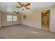 Inviting sunroom featuring neutral wood-paneling, two fans, a large window and plush carpeting at 440 Cottonpatch Rd, Lawrenceville, GA 30046
