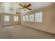 Relaxing sunroom bathed in natural light from many windows, featuring two fans, neutral walls, and carpeted floors at 440 Cottonpatch Rd, Lawrenceville, GA 30046