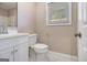 Bathroom featuring a single sink vanity, toilet, mirror and window at 650 Moseley Rd, Stockbridge, GA 30281