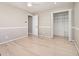 Bright bedroom with a ceiling fan, light wood floors, white trim and a large closet at 650 Moseley Rd, Stockbridge, GA 30281