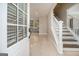 Inviting foyer showcasing wood floors, a staircase with white railings, and a view into the adjacent kitchen at 650 Moseley Rd, Stockbridge, GA 30281
