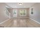 Bright living room with hardwood floors, trim, a doorway, and natural light from the windows at 650 Moseley Rd, Stockbridge, GA 30281