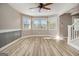 Inviting living area featuring stylish floors, natural light, a ceiling fan, staircase, and views into other rooms at 650 Moseley Rd, Stockbridge, GA 30281