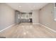 Bright living room with light hardwood floors and gray cabinets seamlessly flowing into a stylish kitchen at 650 Moseley Rd, Stockbridge, GA 30281