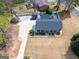 Expansive aerial view of a home featuring a long driveway, pillared porch, and in-ground pool with a safety cover at 3798 Cumberland Way, Lithonia, GA 30038