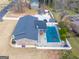 Drone view showing the layout of a brick home, screened porch, pool area, gazebo, and mature surrounding trees at 3798 Cumberland Way, Lithonia, GA 30038