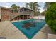 A large backyard featuring a covered pool and an elevated screened porch, offering a serene and private outdoor space at 3798 Cumberland Way, Lithonia, GA 30038