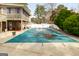 Generous backyard with a pool under a protective cover, accompanied by an elevated deck, ideal for Gathering enjoyment at 3798 Cumberland Way, Lithonia, GA 30038
