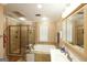 This bathroom features a walk-in shower and tub, neutral colors, and modern lighting at 3798 Cumberland Way, Lithonia, GA 30038