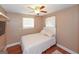 This is a cozy bedroom with neutral colors, a ceiling fan, and a comfortable-looking bed at 3798 Cumberland Way, Lithonia, GA 30038