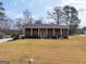 Traditional brick home featuring a symmetrical facade, white pillars, and a well-manicured front lawn at 3798 Cumberland Way, Lithonia, GA 30038