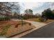 Well-maintained front yard featuring lush landscaping, mature trees, and a classic brick home at 3798 Cumberland Way, Lithonia, GA 30038