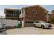 Rear exterior featuring a 2-car garage, a screened-in balcony, and a well-maintained brick facade at 3798 Cumberland Way, Lithonia, GA 30038