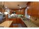 Spacious kitchen with granite countertops, stainless steel appliances, and wood cabinets at 3798 Cumberland Way, Lithonia, GA 30038