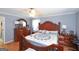 Spacious main bedroom featuring a large bed, hardwood floors, and soft lighting at 3798 Cumberland Way, Lithonia, GA 30038