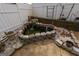 Charming backyard pond with a waterfall feature, enclosed by decorative stones, adding tranquility to the landscape at 3798 Cumberland Way, Lithonia, GA 30038