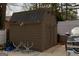 A well maintained storage shed with a weathered exterior and adequate space for tools and equipment at 3798 Cumberland Way, Lithonia, GA 30038