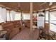 Cozy sunroom with comfortable seating, a refrigerator, and outdoor views for relaxation and entertainment at 3798 Cumberland Way, Lithonia, GA 30038