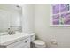 Bright half bath featuring a white vanity and white fixtures at 4967 Post Road Pass, Stone Mountain, GA 30088