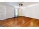 Hardwood-floored bedroom with a window providing lots of light and a ceiling fan at 4967 Post Road Pass, Stone Mountain, GA 30088