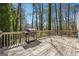 Wooden deck with a grill surrounded by trees at 4967 Post Road Pass, Stone Mountain, GA 30088