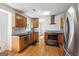 Modern kitchen with stainless steel appliances, wooden cabinets, and stylish countertops at 4967 Post Road Pass, Stone Mountain, GA 30088
