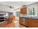 Eat-in kitchen features stainless appliances, wooden cabinets, and bright natural light at 4967 Post Road Pass, Stone Mountain, GA 30088