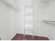 Bright walk-in closet with carpet, built-in shelving and hanging rack at 4967 Post Road Pass, Stone Mountain, GA 30088
