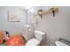 This bathroom has a sink, toilet, flower painting, mirror, and a shelf at 3015 Gold Creek Dr, Villa Rica, GA 30180