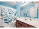 Bathroom featuring a patterned shower curtain, modern sink, and blue accent walls at 3015 Gold Creek Dr, Villa Rica, GA 30180