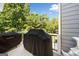 Deck with black grills covered by black covers and trees in the background at 3015 Gold Creek Dr, Villa Rica, GA 30180