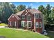 Charming brick home with manicured lawn, complemented by beautiful landscaping and a welcoming entrance at 3015 Gold Creek Dr, Villa Rica, GA 30180