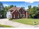Expansive brick home features a well-kept lawn, complemented by a side-entry garage and professional landscaping at 3015 Gold Creek Dr, Villa Rica, GA 30180