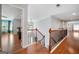 Hallway with hardwood floors, decorative railing, and views into the living space at 3015 Gold Creek Dr, Villa Rica, GA 30180