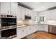 Contemporary kitchen featuring white cabinets, stainless steel appliances, granite countertops, and hardwood floors at 3015 Gold Creek Dr, Villa Rica, GA 30180