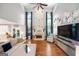 Spacious living room with tall ceilings, fireplace, hardwood floors, and large windows providing ample natural light at 3015 Gold Creek Dr, Villa Rica, GA 30180