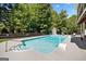 Backyard pool with a diving board and lounge chairs in a fenced backyard at 3015 Gold Creek Dr, Villa Rica, GA 30180