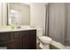 This bathroom features a dark vanity, large mirror, and a toilet at 11882 Fuller St, Hampton, GA 30228