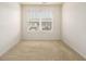 This empty bedroom features a large window at 11882 Fuller St, Hampton, GA 30228