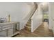 Inviting entryway features wood-look floors and stairs, leading to the upper level of the home at 11882 Fuller St, Hampton, GA 30228