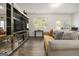 Bright living room with large windows, comfortable seating, and a modern entertainment center at 11882 Fuller St, Hampton, GA 30228