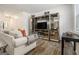 Spacious living room showcases modern furniture, stylish shelving, and natural light from a window at 11882 Fuller St, Hampton, GA 30228