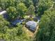 Aerial view of the backyard and home exterior with new roof, siding and lush surrounding trees at 1893 Burning Tree, Decatur, GA 30032