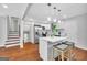 Bright kitchen with island, stainless steel appliances, white cabinets, and hardwood floors at 1893 Burning Tree, Decatur, GA 30032