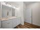 Bathroom with a dual sink vanity, wood flooring, and modern lighting fixtures at 105 Creekside Knl, Grantville, GA 30220
