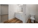 Bathroom featuring a double vanity, wood flooring, and access to the toilet room at 105 Creekside Knl, Grantville, GA 30220
