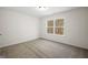 Bedroom with plush carpet, white walls, and a bright window at 105 Creekside Knl, Grantville, GA 30220