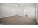 Spacious carpeted bedroom with neutral tones, ceiling fan, and natural light at 105 Creekside Knl, Grantville, GA 30220