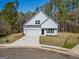 Two-story house with two-car garage, complemented by a spacious driveway and beautiful yard at 105 Creekside Knl, Grantville, GA 30220